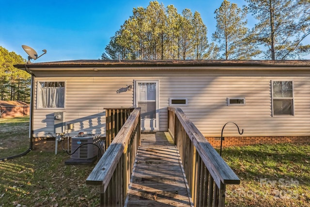 back of house featuring a yard and central AC