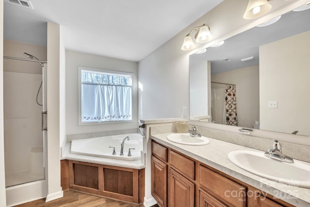 bathroom with separate shower and tub, vanity, and wood-type flooring