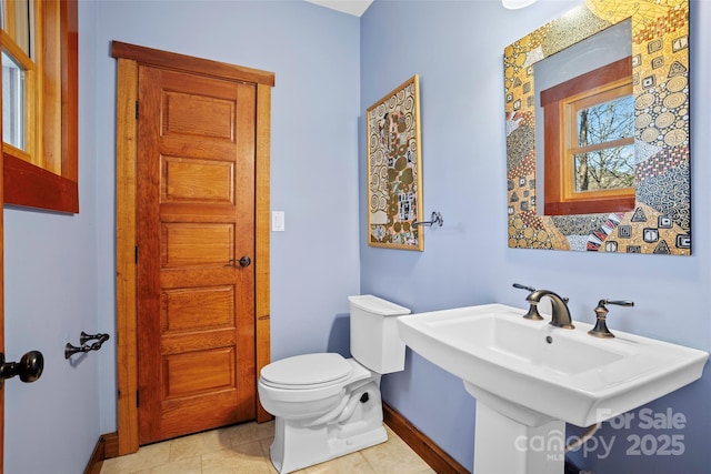 bathroom featuring sink, tile patterned floors, and toilet