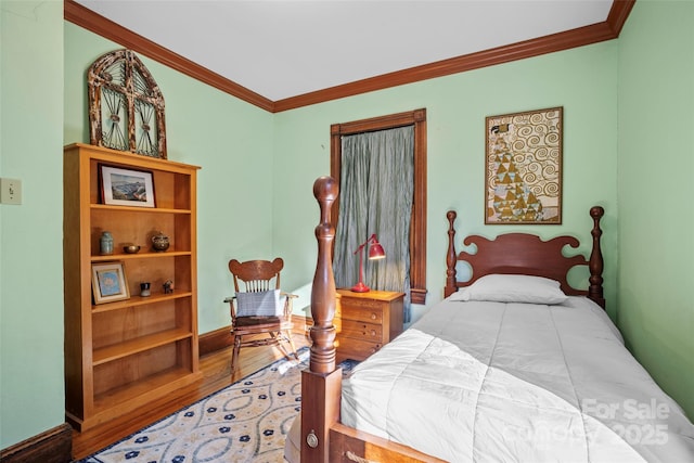 bedroom featuring hardwood / wood-style flooring and crown molding