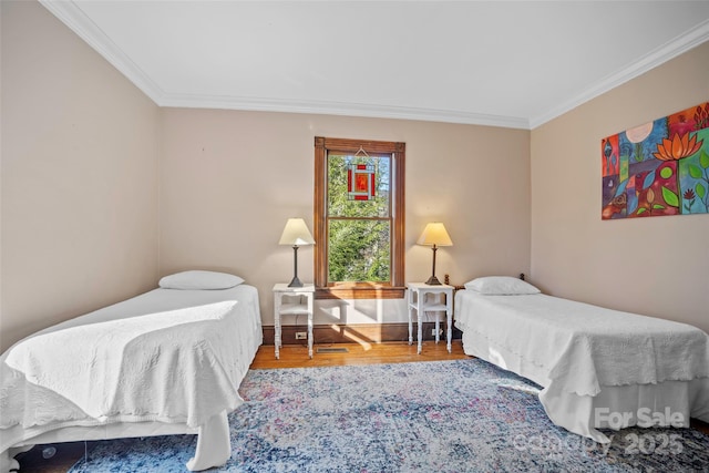 bedroom featuring crown molding and hardwood / wood-style floors