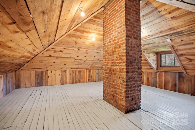 bonus room with vaulted ceiling, hardwood / wood-style flooring, wooden walls, and wooden ceiling