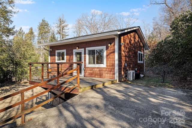 view of front of house with a deck and central AC