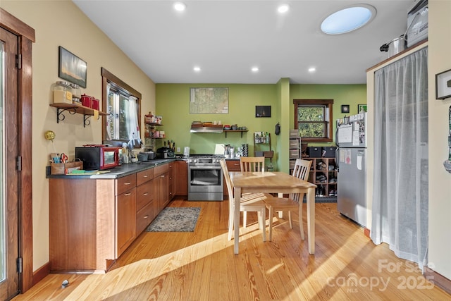 kitchen featuring sink, light hardwood / wood-style flooring, and stainless steel range with gas cooktop