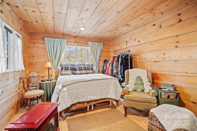 bedroom featuring wood ceiling, wood walls, and hardwood / wood-style flooring