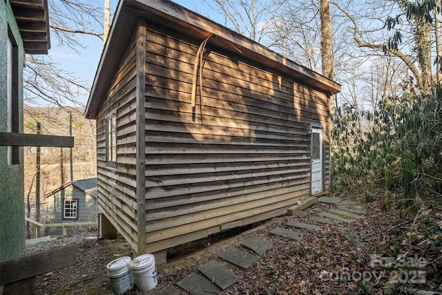 view of home's exterior with a storage shed