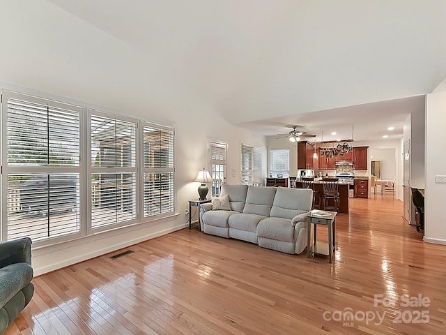 living room featuring ceiling fan and light wood-type flooring