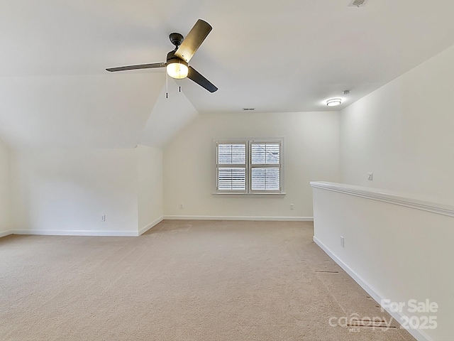 bonus room with vaulted ceiling, light colored carpet, and ceiling fan