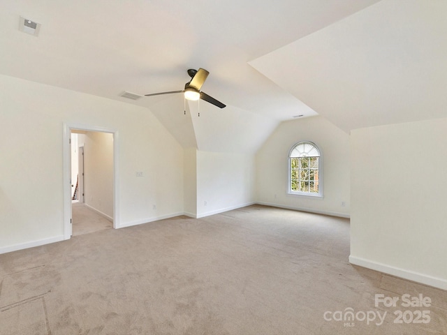 bonus room with vaulted ceiling, light colored carpet, and ceiling fan