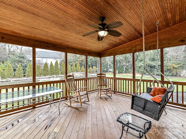 sunroom with vaulted ceiling, wooden ceiling, and ceiling fan