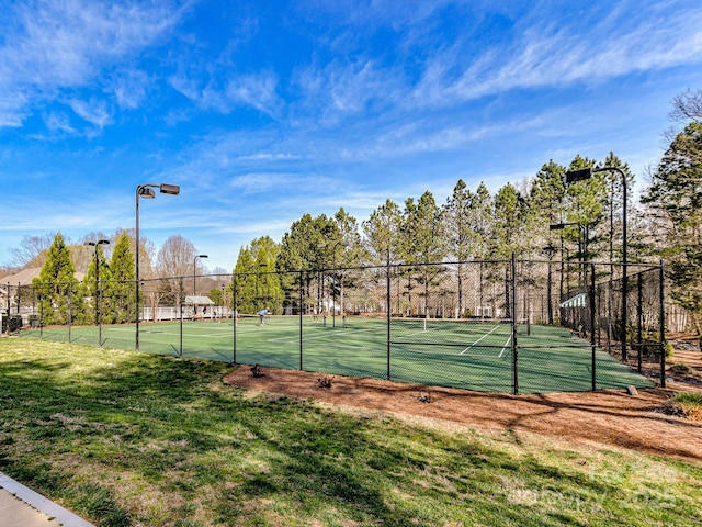 view of sport court featuring a yard