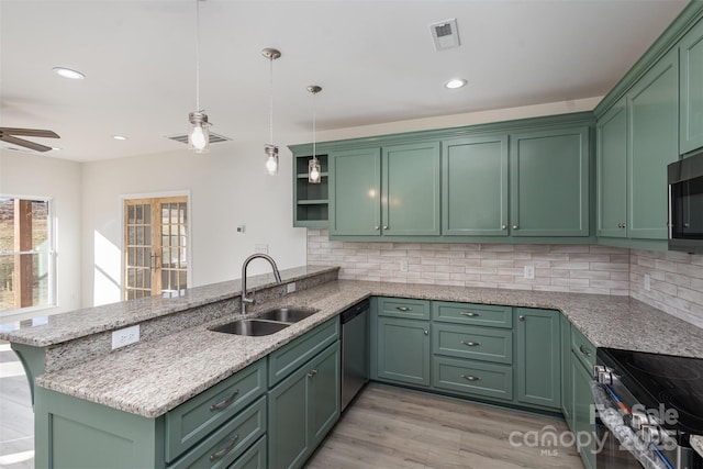 kitchen featuring kitchen peninsula, appliances with stainless steel finishes, hanging light fixtures, green cabinetry, and sink