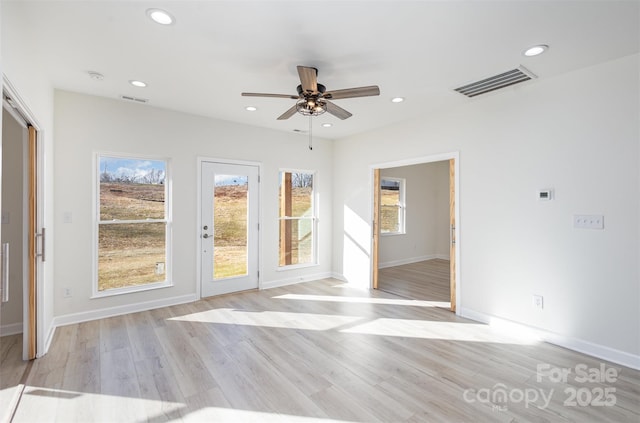 spare room with ceiling fan and light hardwood / wood-style floors