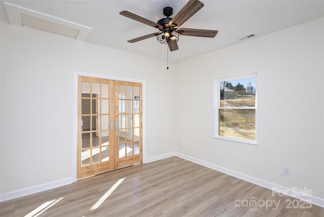 unfurnished room with ceiling fan, french doors, and light hardwood / wood-style flooring