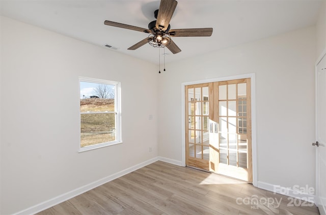 empty room featuring ceiling fan and light wood-type flooring