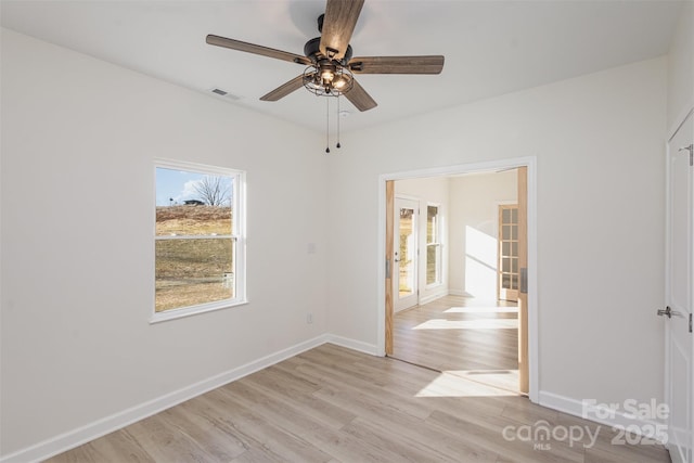 unfurnished room featuring light wood-type flooring and ceiling fan