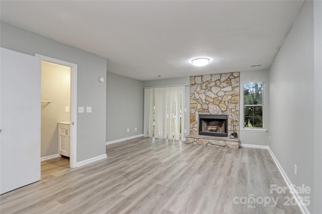 unfurnished living room with light hardwood / wood-style floors and a fireplace