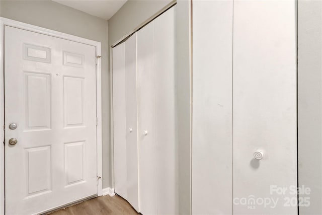 corridor with light hardwood / wood-style flooring