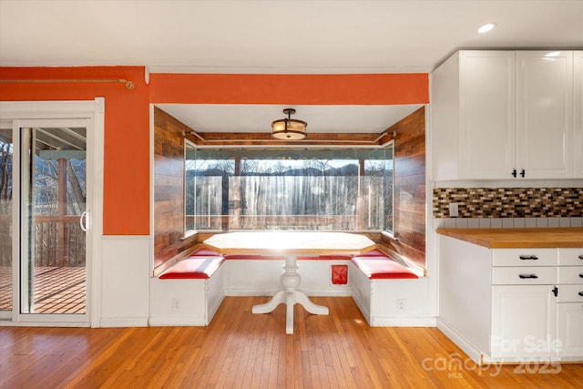 unfurnished dining area featuring light wood-type flooring and breakfast area