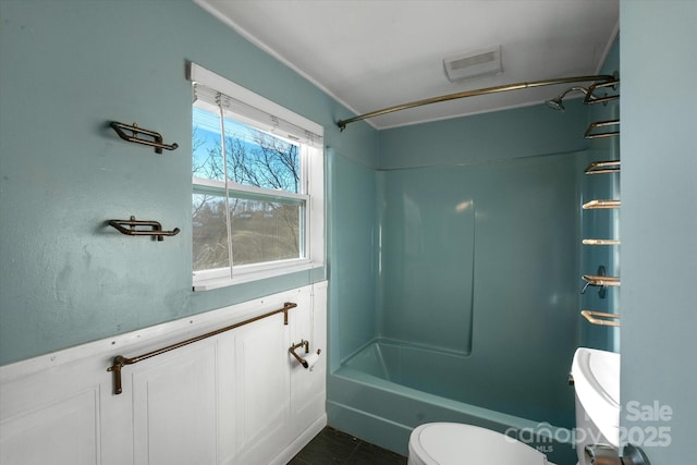 bathroom featuring toilet, tile patterned flooring, and tub / shower combination