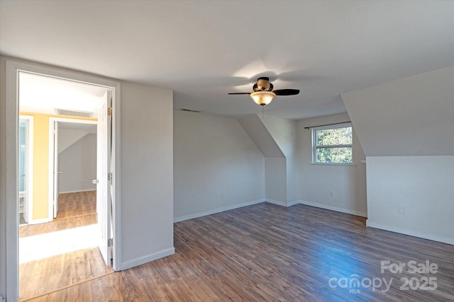 bonus room with ceiling fan, dark hardwood / wood-style floors, and vaulted ceiling