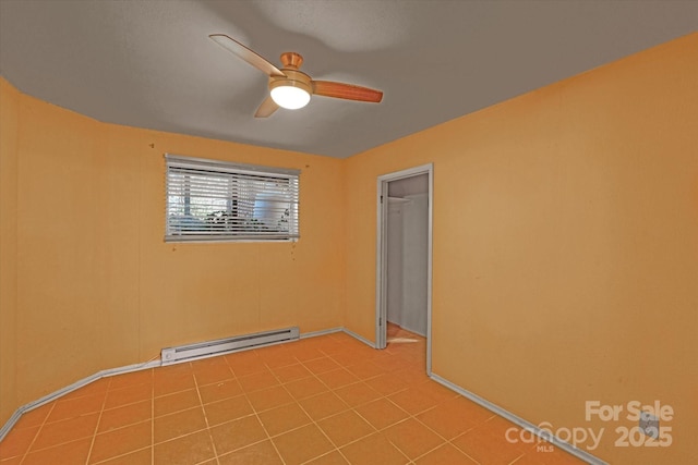 unfurnished room featuring ceiling fan and a baseboard heating unit