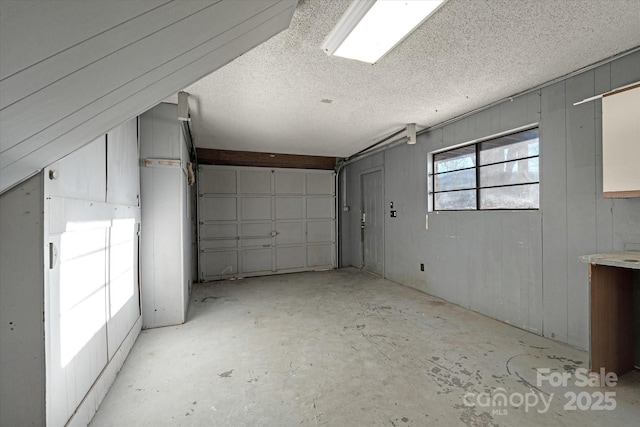 garage featuring wood walls