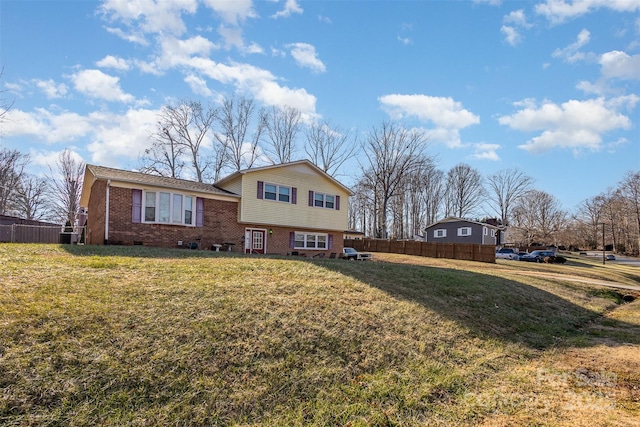 tri-level home featuring a front lawn