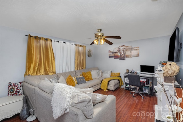 living room with dark wood-type flooring and ceiling fan