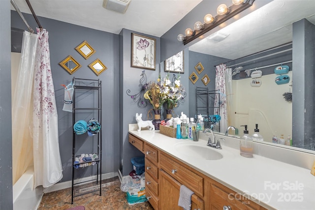 bathroom with shower / bath combo and vanity