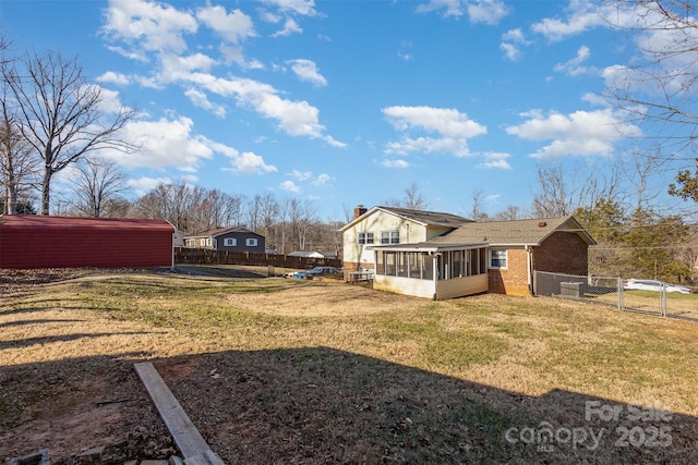 back of house with a yard and a sunroom