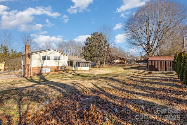 view of yard with a sunroom