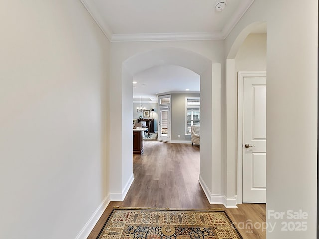 hall featuring hardwood / wood-style flooring and crown molding