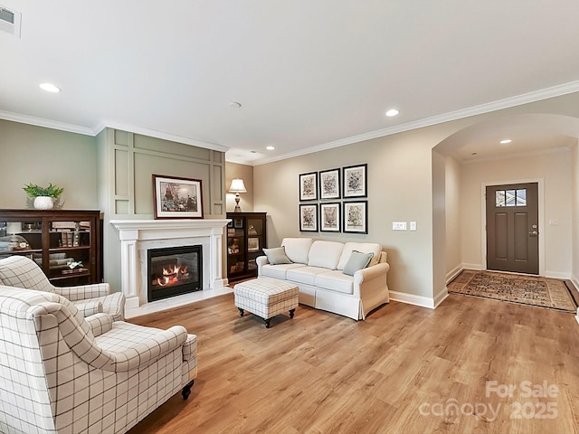 living room featuring light hardwood / wood-style flooring and ornamental molding