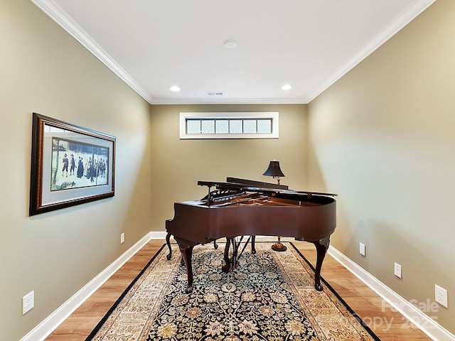 interior space with hardwood / wood-style flooring and ornamental molding