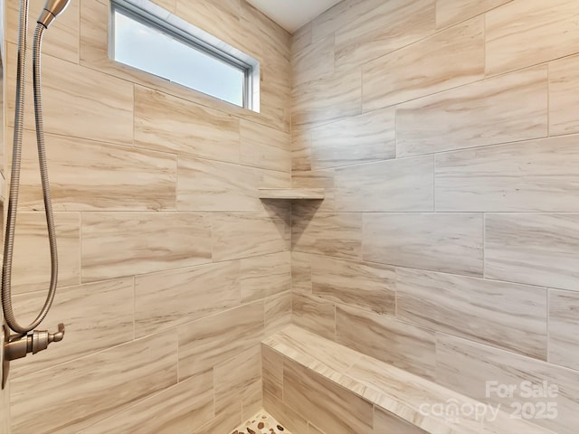 bathroom featuring a tile shower