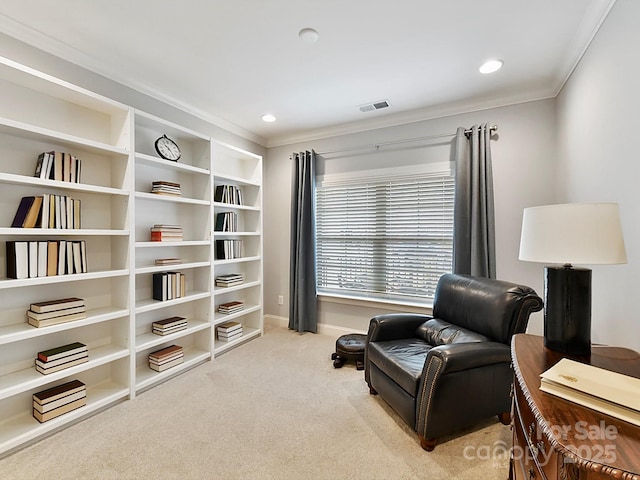 sitting room with crown molding and light colored carpet