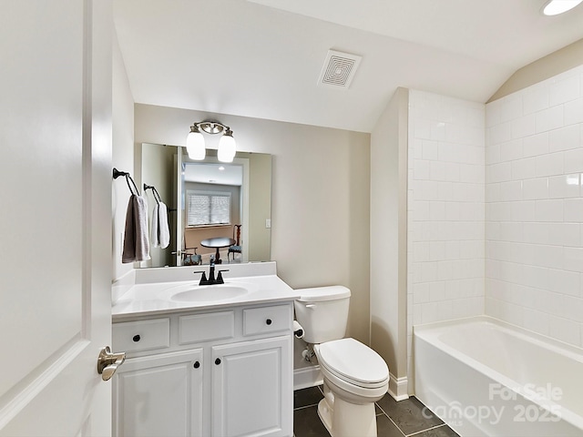 full bathroom featuring shower / tub combination, vaulted ceiling, vanity, toilet, and tile patterned floors