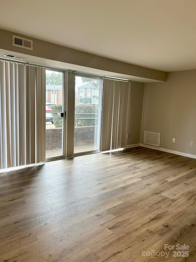 spare room featuring light hardwood / wood-style flooring