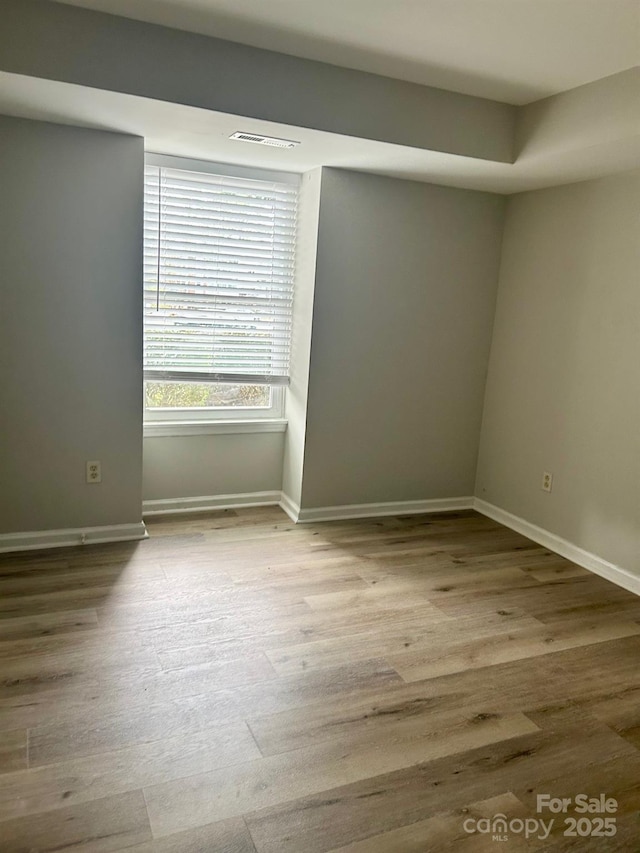 spare room featuring light hardwood / wood-style flooring