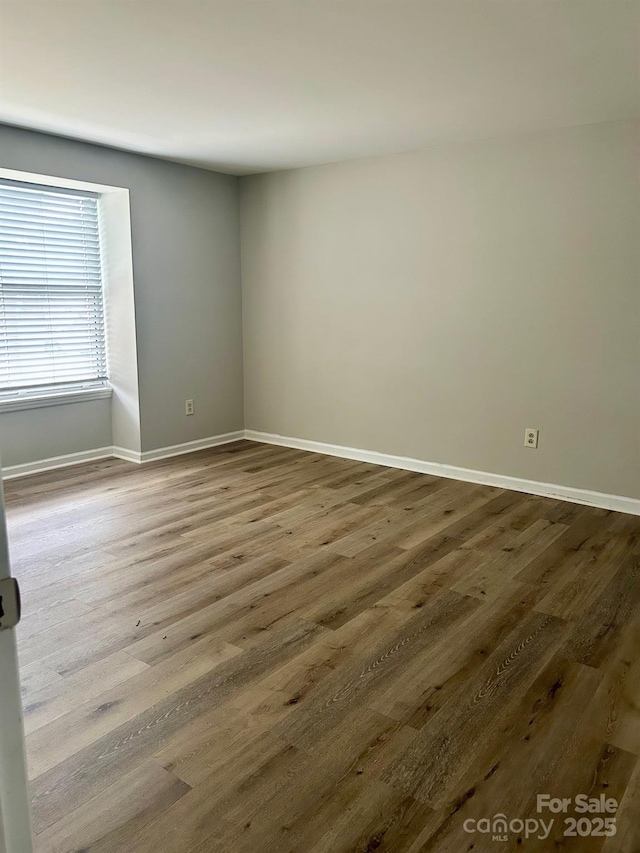 unfurnished room featuring hardwood / wood-style floors