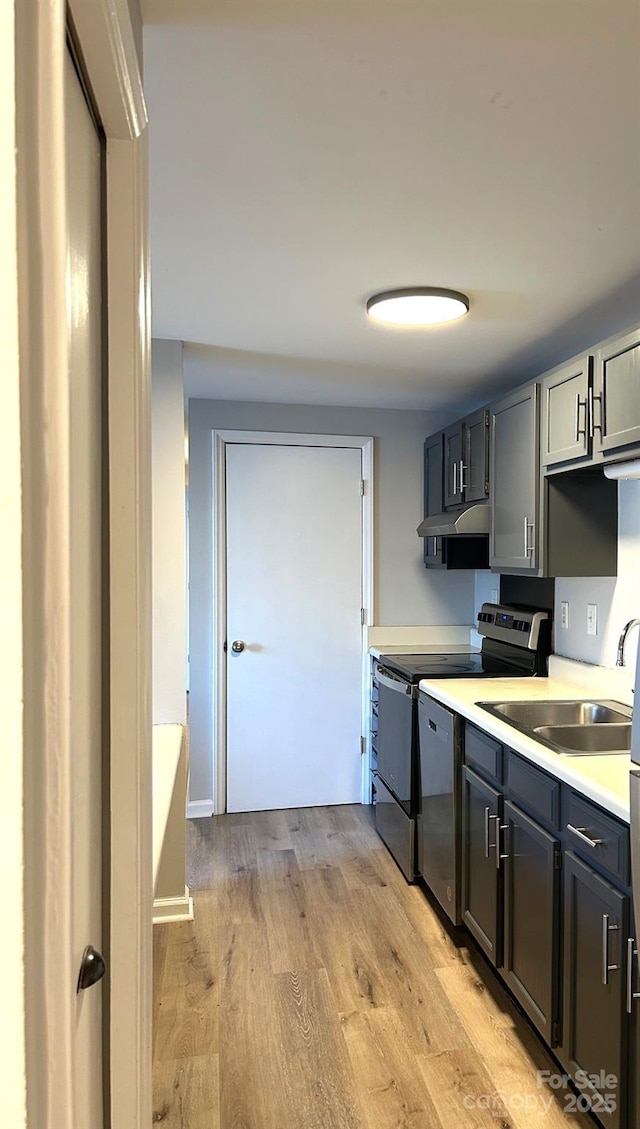 kitchen with appliances with stainless steel finishes, light hardwood / wood-style floors, sink, and gray cabinetry