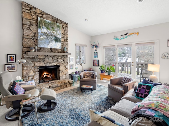 living room featuring a textured ceiling, carpet flooring, a fireplace, and vaulted ceiling