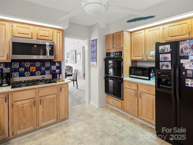 kitchen with backsplash, light stone countertops, ceiling fan, and black appliances