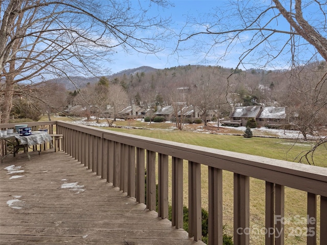 wooden deck with a lawn and a mountain view