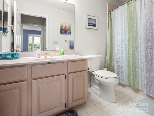 bathroom featuring toilet, vanity, and tile patterned floors