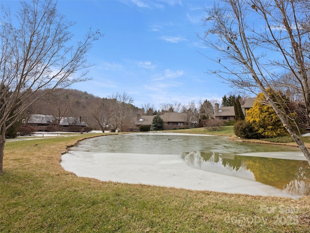 view of home's community featuring a yard and a water view