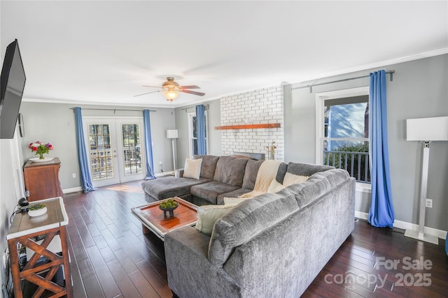 living room with ceiling fan, dark hardwood / wood-style flooring, ornamental molding, and french doors