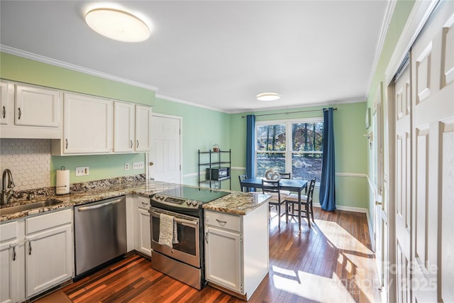 kitchen featuring kitchen peninsula, appliances with stainless steel finishes, white cabinetry, and sink