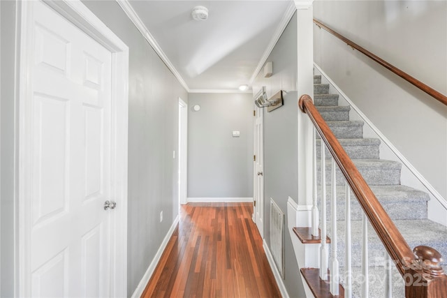 hallway with dark hardwood / wood-style flooring and ornamental molding